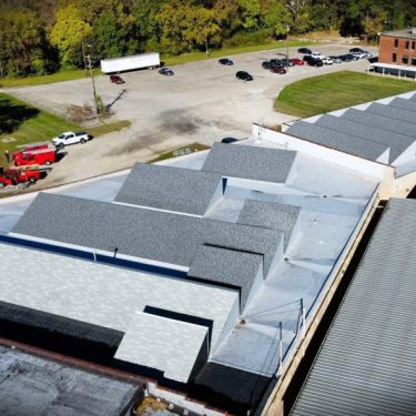 In phase 1 of this multi-year project, Molloy Roofing Company removed the existing SPF and asbestos-impacted roofing across the multiple roof areas and install new insulated Elevate TPO roof systems with improved drainage, upgraded flashing, elimination of obsolete penetrations and skylights, and a new roof hatch. The monitor dormers across these sections were fully rebuilt with new insulation, sheathing, CertainTeed Landmark shingles, and TPO-clad wall assemblies to provide long-term durability, enhanced weather protection, and improved energy performance. In phase 1 of this multi-year project, Molloy Roofing Company removed the existing SPF and asbestos-impacted roofing across the multiple roof areas and install new insulated Elevate TPO roof systems with improved drainage, upgraded flashing, elimination of obsolete penetrations and skylights, and a new roof hatch. The monitor dormers across these sections were fully rebuilt with new insulation, sheathing, CertainTeed Landmark shingles, and TPO-clad wall assemblies to provide long-term durability, enhanced weather protection, and improved energy performance.