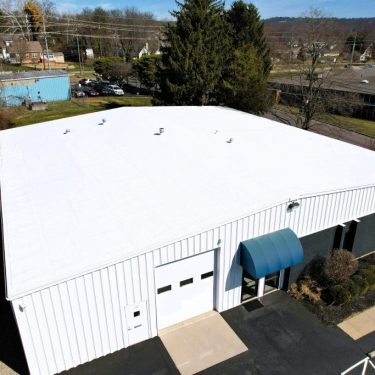 Molloy Roofing Company re-roofed using a Carlisle Sure-Weld white TPO roofing system installed over the existing standing seam metal roof in Fairfax, Ohio. The project includes installation of tapered EPS insulation to fill roof flutes, followed by a leveling recover board to create a smooth, insulated surface. Molloy Roofing Company re-roofed using a Carlisle Sure-Weld white TPO roofing system installed over the existing standing seam metal roof in Fairfax, Ohio. The project includes installation of tapered EPS insulation to fill roof flutes, followed by a leveling recover board to create a smooth, insulated surface.
